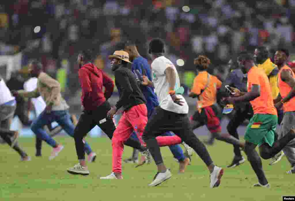 Fans invade the soccer field after the match Ivory Coast vs Algeria where Ivoy Coast beat Algeria 3-1 in Cameroon on Jan. 20, 2022.