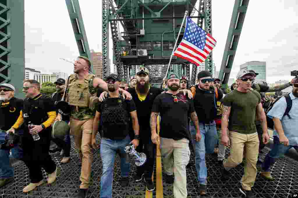 Members of the Proud Boys and other right-wing demonstrators march across the Hawthorne Bridge during an &quot;End Domestic Terrorism&quot; rally in Portland, Oregon, USA, Aug. 17, 2019.