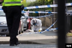 A crime scene investigator works at the scene where Jo Cox was murdered on Thursday.