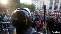Pro-Russian activists hold a rally near the headquarters of the regional interior ministry to demand the resignation of its head Anatoly Naumenko in Luhansk, eastern Ukraine, May 7, 2014.