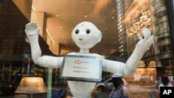 HSBC Bank welcomes SoftBank Robotics' humanoid robot, Pepper, to their team at the Fifth Ave branch on Monday, June 25, 2018 in New York. (Mark Von Holden/AP Images for HSBC)