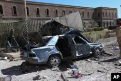 This photo provided by Yemen's Defense Ministry shows damaged vehicles after an explosion at the Defense Ministry complex in Sana'a, Dec. 5, 2013.