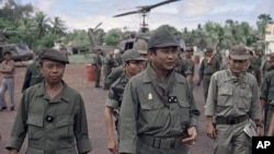 Lt. General Lon Nol, the Cambodian Prime Minister (foreground three stars) is followed by his high-command at the end of a visit they made to Skuon the task force headquarters in Cambodia on Sept. 23, 1973. The group made the fight to and from Phnom Penh via helicopters. (AP Photo/Max Nash)