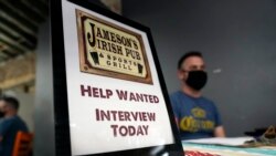 FILE - A hiring sign is shown at a booth for Jameson's Irish Pub during a job fair on Sept. 22, 2021, in the West Hollywood section of Los Angeles.