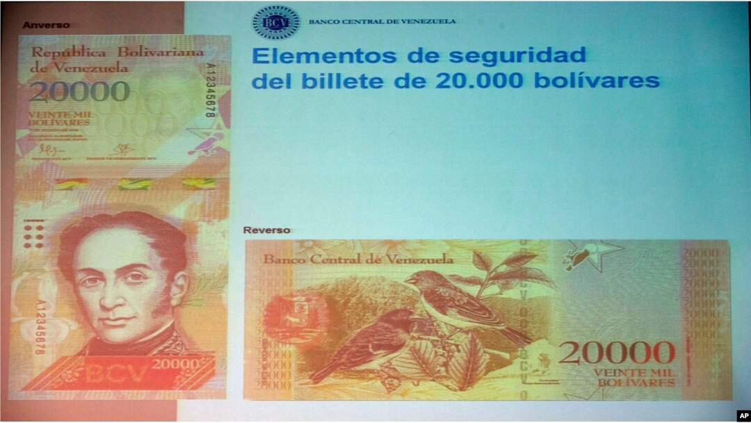 The front and back of the newly issued 20,000 bolivar note is displayed during a news conference in Caracas, Venezuela, Dec. 7, 2016.