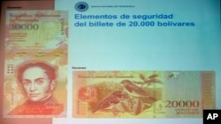 The front and back of the newly issued 20,000 bolivar note is displayed during a news conference in Caracas, Venezuela, Dec. 7, 2016.