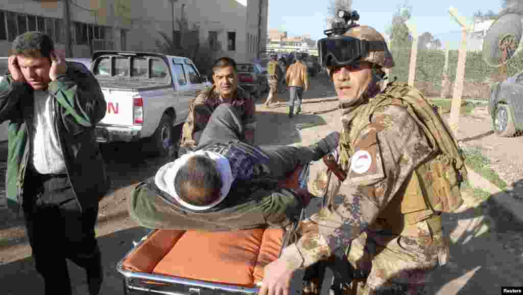 A wounded man is transported on a stretcher to receive treatment after a suicide attack in Kirkuk, 250 kilometers north of Baghdad, January 16, 2013.