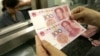China Devaluasi Mata Uang 2 Persen