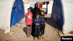 Displaced Iraqi Orouba Abdelhamid, 31, poses for a photograph with her children at Hammam al-Alil camp south of Mosul, Iraq, April 1, 2017. Abdelhamid's husband, an engineer, was killed in a rocket strike as government forces arrived to expel Islamic State from her home city Mosul. "No one is left for me over there so I came here... I cannot return to the house," she said.