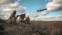 In this image released by Ukrainian Defense Ministry Press Service, Ukrainian soldiers use a launcher with U.S. Javelin missiles during military exercises in Donetsk region, December 23, 2021.