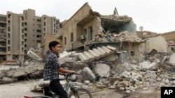 An Iraqi boy inspects Baghdad buildings damaged by bombs (file photo)