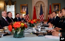 Secretary of Defense Jim Mattis, left, Secretary of State Mike Pompeo, second from left, Chinese Politburo member Yang Jiechi, third from right, and Chinese State Councilor and Defense Minister Gen. Wei Fenghe, second from right, meet at the State Department in Washington, Nov. 9, 2018.