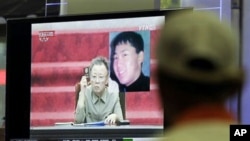A South Korean man in Seoul watches a TV news program showing North Korean leader Kim Jong Il as he appointed youngest son, Kim Jong Un - shown in portrait at top right - as an army general in an apparent sign he is being groomed as country's next leader,