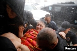 Rescue workers carry a woman into the Emergency Operation Center after the area was hit by Hurricane Maria in Guayama, Puerto Rico, Sept. 20, 2017.