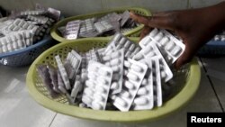 FILE - Ruth Munyao, a pharmacist, dispenses antiretroviral (ARV) drugs at the Mater Hospital in Kenya's capital Nairobi, Sept. 10, 2015. 