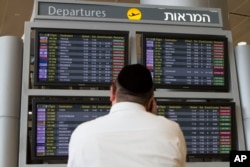 A departure flight board displays various cancelled and delayed flights at Ben Gurion International Airport a day after the U.S. FAA imposed a 24-hour restriction on flights, in Tel Aviv, July 23, 2014.