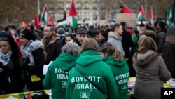 Demonstrators wear shirts reading "Boycott Israel" during a protest against President Donald Trump's decision to recognize Jerusalem as Israel's capital at Republique Square in Paris, France, Saturday, Dec. 9, 2017.