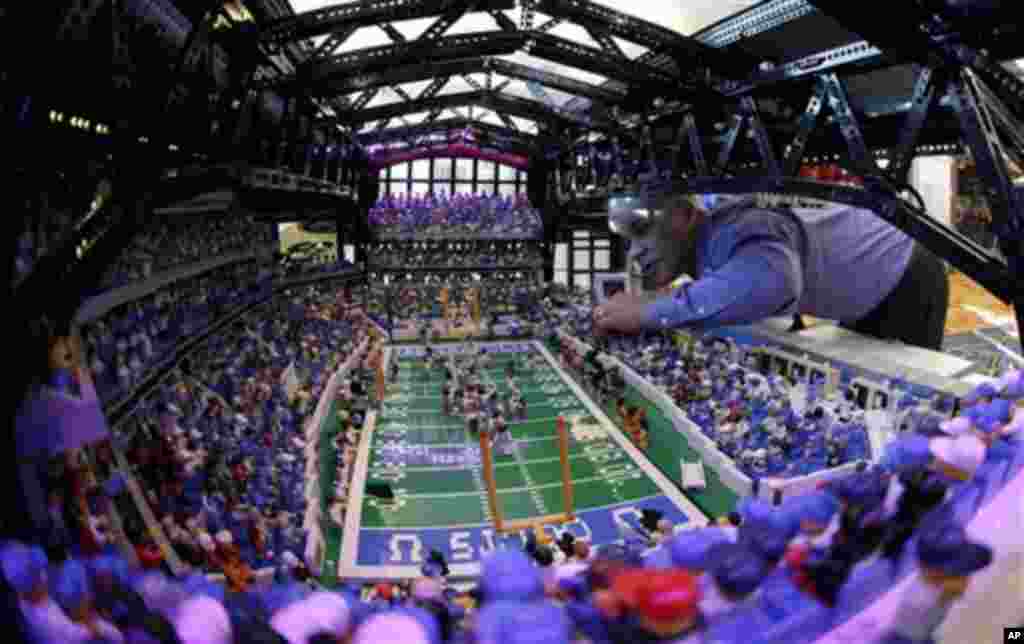 Brian Alano adjusts a piece in his Lego scaled replica of Lucas Oil Stadium which is on display at the Super Bowl XLVI media center Wednesday, Feb. 1, 2012, in Indianapolis. Alano spent three years and used over 30,000 pieces to build the model. The New E