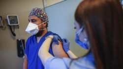 In this Oct. 9, 2020, file photo, a health worker, right, administers the first dose of a COVID-19 vaccine currently on phase III clinical trials to Cem Gun, an emergency medicine physician at the Acibadem Hospital in Istanbul.(AP Photo/Emrah Gurel, File