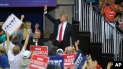 President Donald Trump waves as he leaves a campaign rally, June 20, 2018, in Duluth, Minn.