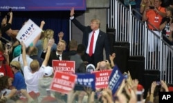 President Donald Trump waves as he leaves a campaign rally, June 20, 2018, in Duluth, Minn.