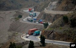 Trucks carry goods on the way to neighboring Afghanistan through the Khyber Pass in Pakistani tribal area, March 21, 2017. A Pakistani border official says hundreds of trucks have crossed into Afghanistan from Pakistan after the border reopened for the first time in more than a month.