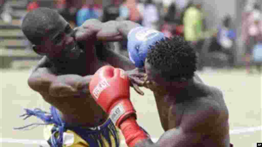 Bahago Yellow of Maiduguri state, left, fights with Bahago Balgori of Kaduna state, right, in the 65 Kg bout in the traditional Nigerian boxing ''Dambe'' contest.