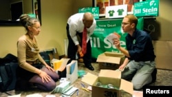 FILE - Campaign workers for presidential candidate Jill Stein sort campaign materials as delegates gather for the Green Party presidential nominating convention in Baltimore, Maryland, July 14, 2012.