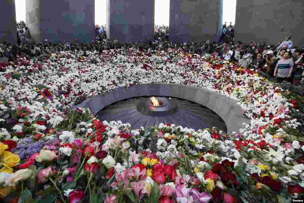 People lay flowers to commemorate the 103rd anniversary of mass killing of Armenians by Ottoman Turks, at the Tsitsernakaberd Memorial Complex in Yerevan, Armenia.