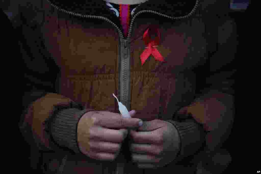 A Nepalese woman from &quot;Maiti Nepal&quot;, a rehabilitation center for victims of sex trafficking, holds a candle before she lights it on the eve of World AIDS Day in Kathmandu, Nov. 30, 2016.