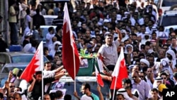 Mourners carry the casket of Bahia al-Aradi through the streets of downtown Manama, Bahrain, March 22, 2011