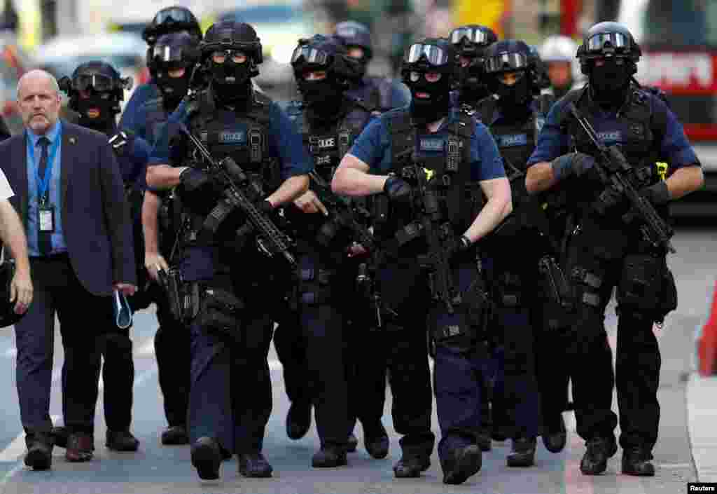 Armed police officers walk outside Borough Market after an attack left seven people dead and dozens injured in London, Britain.