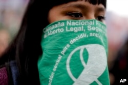 A demonstrator in support of decriminalizing abortion stands outside Congress in Buenos Aires, Argentina, Aug. 8, 2018.