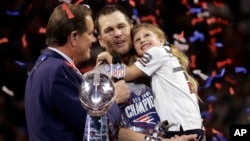 New England Patriots' Tom Brady holds his daughter, Vivian, after the NFL Super Bowl 53 football game against the Los Angeles Rams, Sunday, Feb. 3, 2019, in Atlanta. 