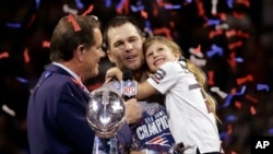 New England Patriots' Tom Brady holds his daughter, Vivian, after the NFL Super Bowl 53 football game against the Los Angeles Rams, Sunday, Feb. 3, 2019, in Atlanta. 