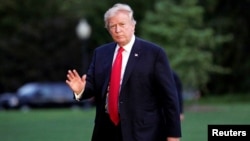 FILE - U.S. President Donald Trump waves as walks on the South Lawn of the White House upon his return to Washington, from the G-20 Summit in Hamburg, July 8, 2017. 