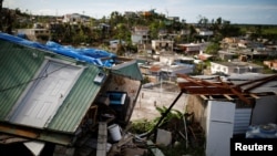 Houses damaged or destroyed by Hurricane Maria stand at the squatter community of Villa Hugo in Canovanas, Puerto Rico, Dec. 11, 2017. 