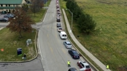 Cars wait in line during a Greater Pittsburgh Community Food bank drive-up food distribution in Duquesne, Pa. (AP Photo/Gene J. Puskar)