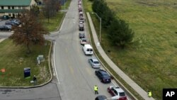 Cars wait in line during a Greater Pittsburgh Community Food bank drive-up food distribution in Duquesne, Pa. (AP Photo/Gene J. Puskar)