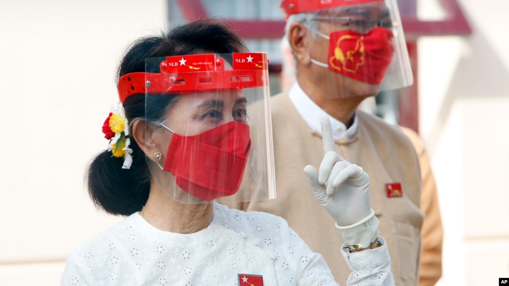 Myanmar leader Aung San Suu Kyi gestures during a flag-raising ceremony to mark the first day of election campaigning at the National League for Democracy party's temporary headquarters in Naypyitaw, Myanmar on Sept. 8, 2020. (AP Photo/Aung Shine Oo)