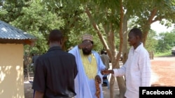 FILE - Dong Samuel Luak, right, greeting South Sudan President Salva Kiir. South Sudan's government has repeatedly denied responsibility for the disappearance of human rights lawyer Dong Samuel Luak and Aggrey Idri. (Photo: Dong's Facebook page)