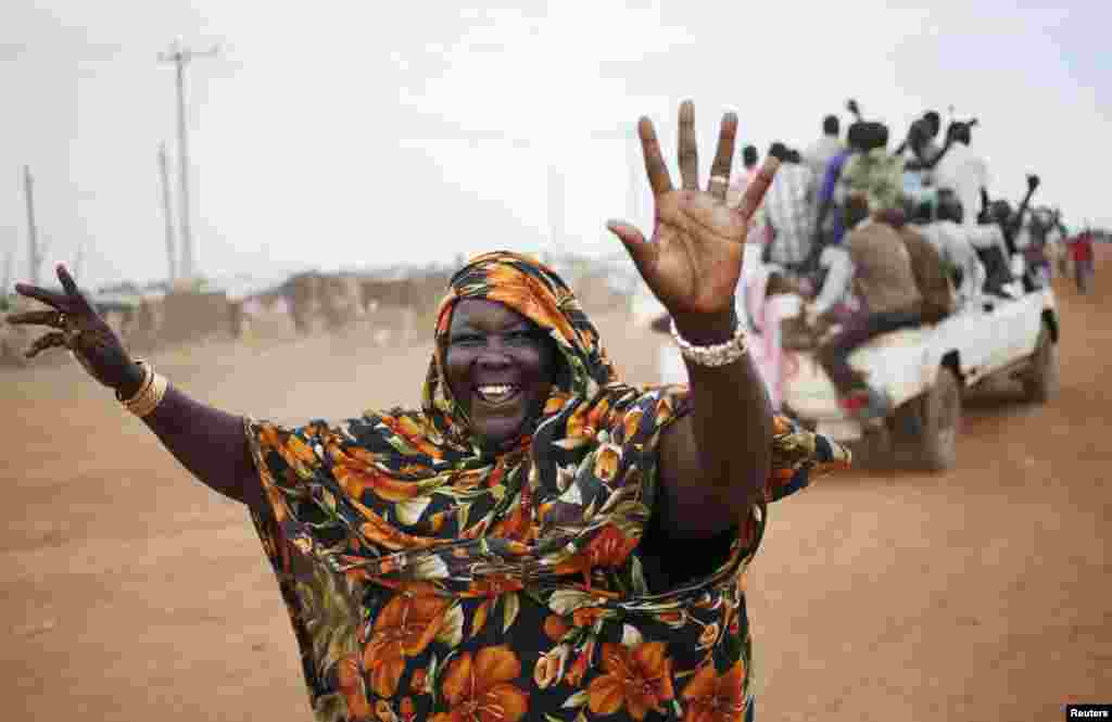 A woman waves to people arriving on vehicles in the town of Abyei ahead of the referendum. Residents of the remote and disputed Abyei border region say they will press on with their own referendum on whether to join Sudan or South Sudan, despite warnings it could trigger violence in the already volatile area.