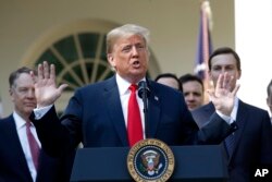 FILE - President Donald Trump announces a revamped North American free trade deal, the U.S.-Mexico-Canada Agreement (USMCA), in the Rose Garden of the White House in Washington, Oct. 1, 2018.