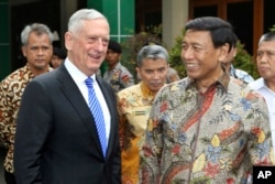 U.S. Defense Secretary Jim Mattis, left, smiles with Indonesian Coordinating Minister for Politics, Security and Law Wiranto after a meeting in Jakarta, Indonesia, Jan. 23, 2018.