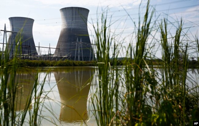 FILEL - Two cooling towers can be seen in the reflection of a pond outside of the unfinished Bellefonte Nuclear Plant, in Hollywood, Alabama, Sept. 7, 2016.