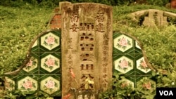 The ornate tile detail on one of the many overgrown graves at Singapore's Bukit Brown Cemetery. (VOA/K. Lamb)