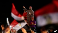 A supporter of Egypt's ousted President Mohammed Morsi wears a mask and chants slogans against Egyptian Defense Minister Gen. Abdel-Fattah el-Sissi, at Rabaah al-Adawiya mosque, in Cairo, Egypt, July 31, 2013.