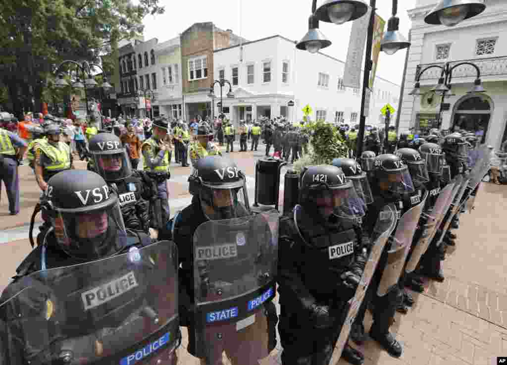 Virginia State Police cordon off an area around the site where a car ran into a group of protesters after a white nationalist rally in Charlottesville, Aug. 12, 2017.