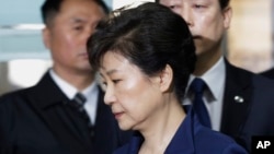 FILE - Ousted South Korean President Park Geun-hye arrives at the Seoul Central District Court for a hearing on a prosecutors' request for her arrest for corruption, in Seoul, South Korea, March 30, 2017.