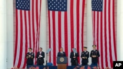 President Barack Obama, center, speaks at a Memorial Day ceremony at Arlington National Cemetery in Arlington, Va., May 25, 2015.